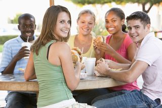 Group-Of-Teenagers-Sitting-Out